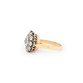 Gold ring with a diamond cluster on a white background