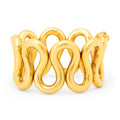 Gold bracelet with a wavy design on a white background