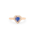 Rose gold ring with a heart-shaped blue gemstone on a white background