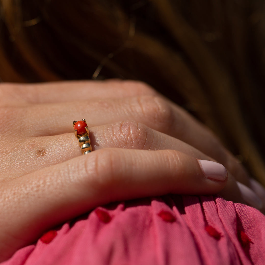 A 9ct gold coral and pearl flower ring, finger size J1/2, weight 2.6gms